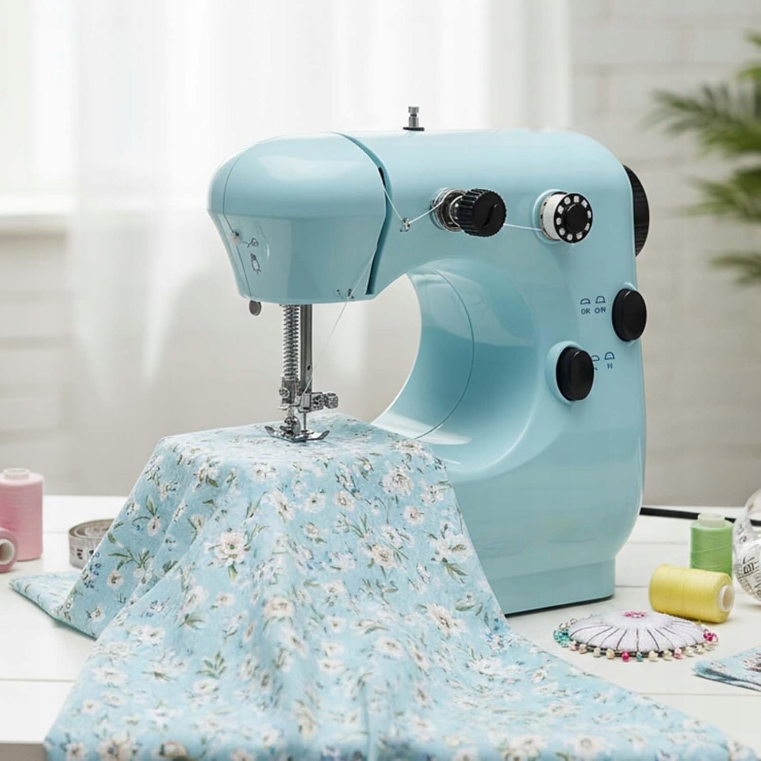SET! Small, portable two-speed sewing machine, with pull-out table! Dominant color white